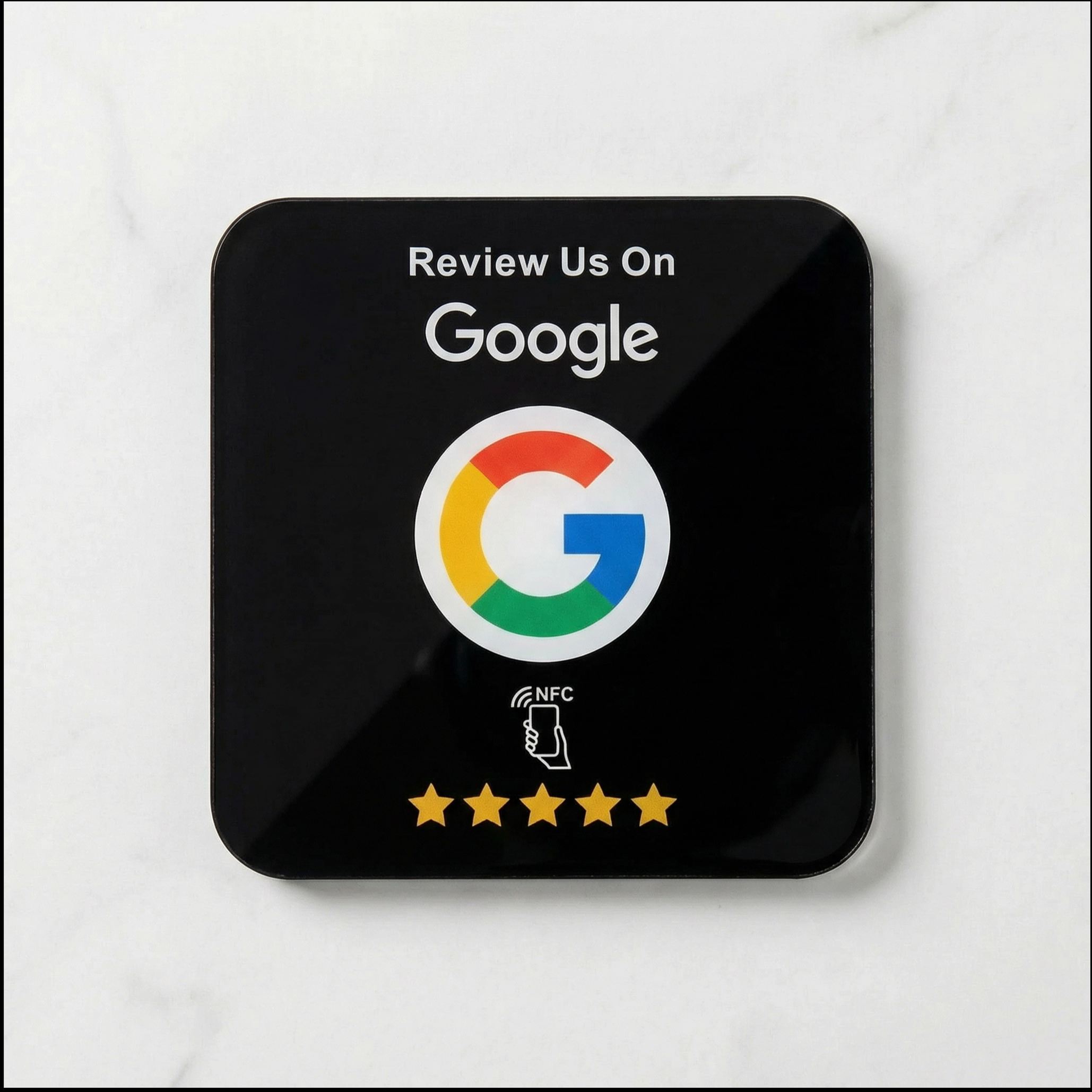 Premium black NFC Google review plate overhead view on marble
